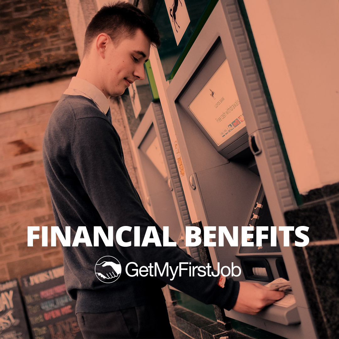 Male apprentice getting money from a cash point