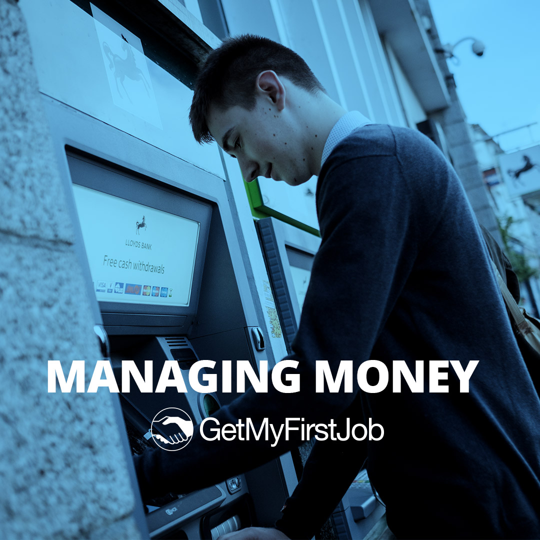 Teenage boy getting money from a cash point