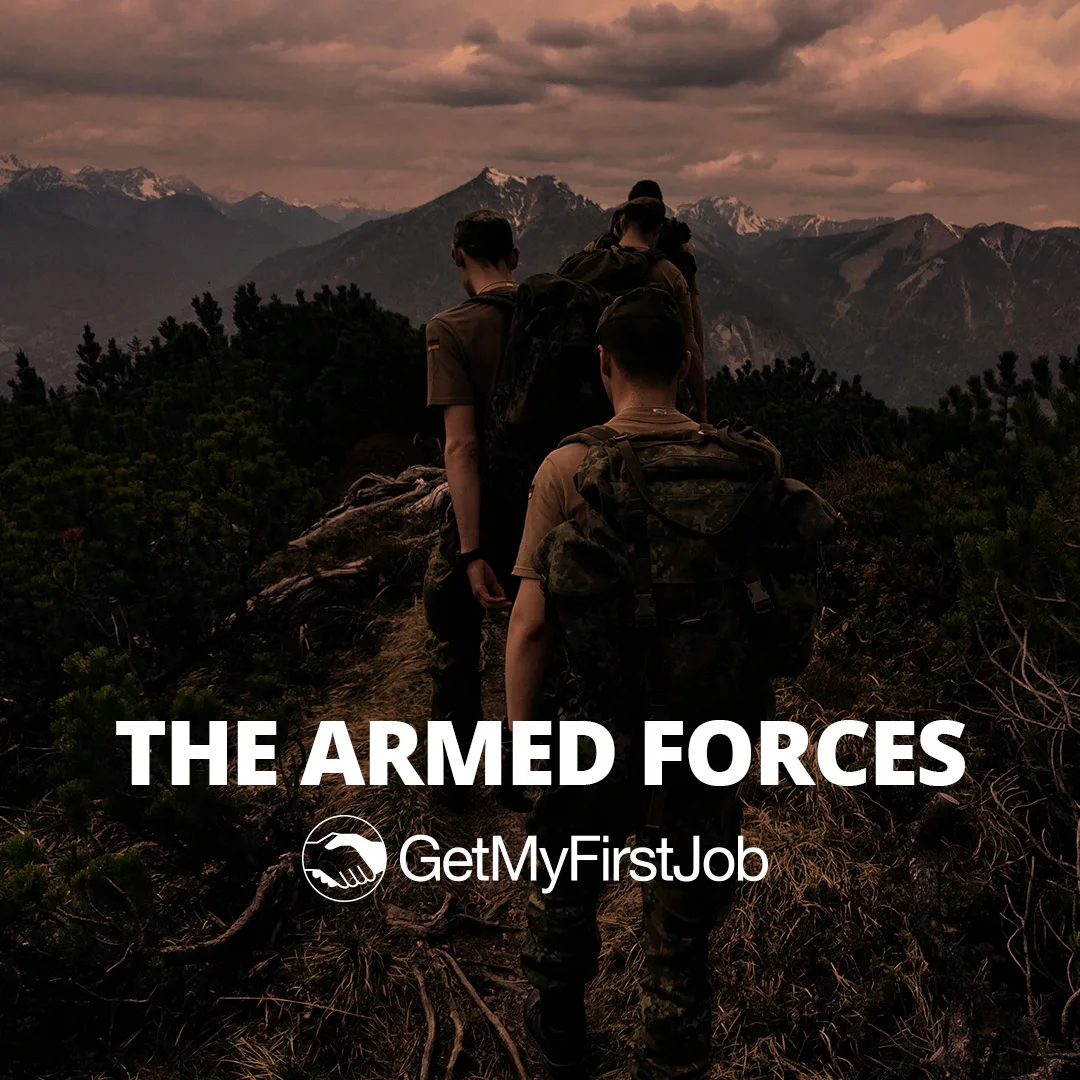 3 people from the army walking across a mountain
