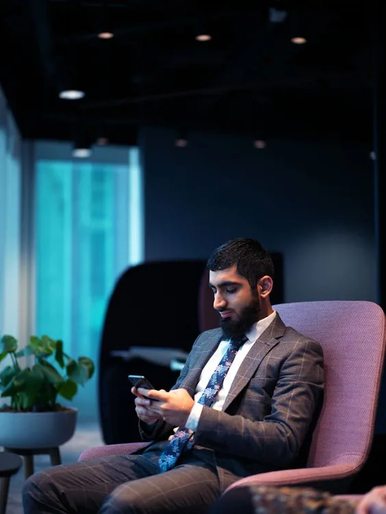 Umayr working on his phone from the BT Group headquarters in London